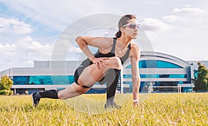 Runner girl warming up on the football field. Sports concept