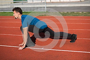 Runner guy doing stretching before jogging