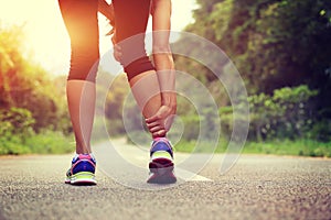 runner hold her sports injured leg