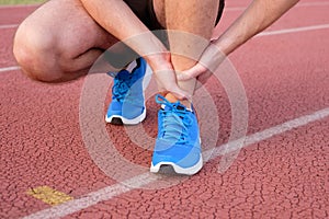 Runner with injured ankle on track