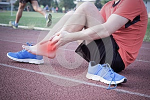 Runner with injured ankle on the track