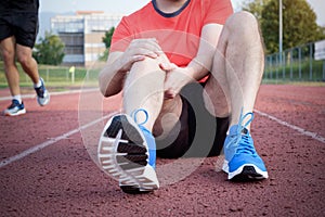 Runner with injured knee on track