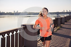 Runner is jogging in sunny bright light on sunrise.