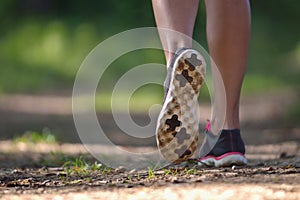 Runner legs on pathway in park