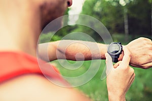 Runner looking checking sport watch