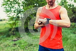 Runner looking at sport smart gps watch