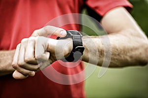 Runner looking at sport watch photo