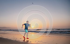 Runner man on the beach be running for exercise. Active healthy runner jogging outdoor. Young man training on the beach