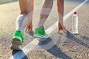 Runner man feet running on road closeup on shoe.