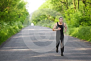 Runner man running on road training sprint. Sporting male run working out outside