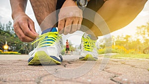 Runner man tying running shoes laces getting ready