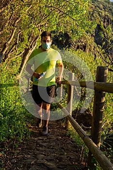 Runner practices trail running in a forest.