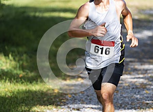 Runner racing on gravel during cross country race