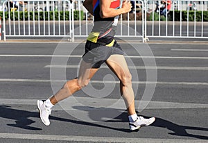 Runner running on city road photo