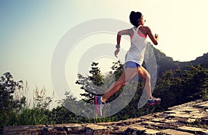 Runner running at great wall on the top of mountain