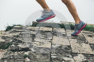 Runner running at great wall on the top of mountain