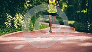 Runner running on morning park road