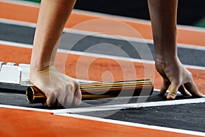 Runner Running a Race on Track with Baton Relay Team Score