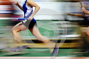 Runner Running a Race on Track with Baton Relay Team Score photo