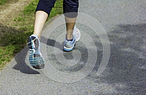 Runner - running shoes closeup on runners shoes feet running on road fitness jog workout healthy lifestyle fitness jogging