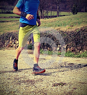 runner with running shoes runs during cross country race with ol