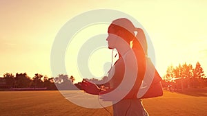 Runner running in a suburb, healthy fitness wellness vitality athlete silhouetted against the sun flare. Young woman