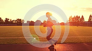 Runner running in a suburb, healthy fitness wellness vitality athlete silhouetted against the sun flare. Young woman