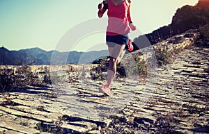 Runner running up to the top of great wall on mountain