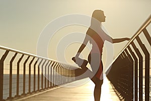 Runner silhouette doing stretching exercise