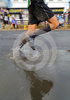 Runner splashing water on the street