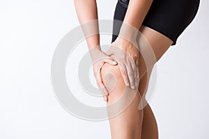 Runner sport knee injury. Closeup young woman in knee pain while running. Healthcare and medical concept