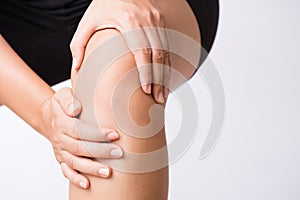 Runner sport knee injury. Closeup young woman in knee pain while running. Healthcare and medical concept