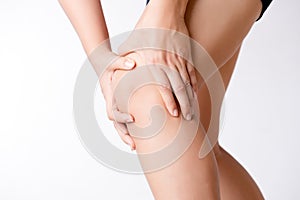 Runner sport knee injury. Closeup young woman in knee pain while running. Healthcare and medical concept