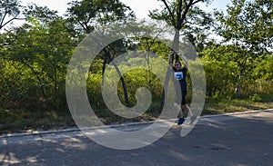 Runner with sportswear and running shoes during the marathon along the city streets