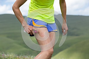 runner spraying insect repellents on skin outdoors