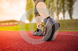 Runner or sprinter is running in stadium at evening