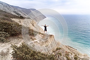 Runner standing on mountains and open arms