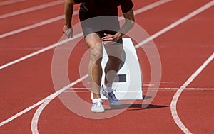 Runner in start position prepares for the start.  Individual sport conept