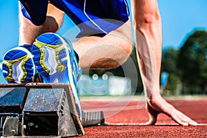 Runner before start signal on starting block of sprint track