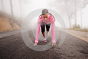 Runner, start and woman on path outdoor in forest, park or woods for exercise in winter. Morning, fog and person with