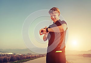 Runner starts his modern stopwatch before jogging