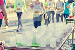 Runner taking a cup of water at H20 stand.