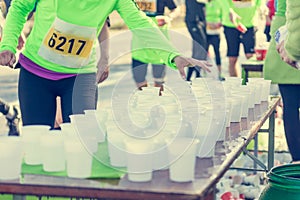 Runner taking a cup of water at H20 stand.