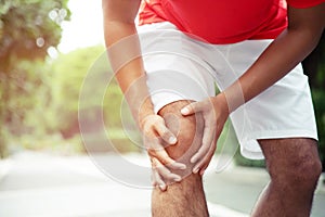 Runner touching painful twisted or broken ankle. Athlete runner training accident