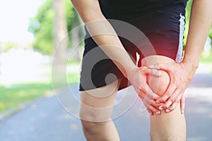 Runner touching painful twisted or broken ankle. Athlete runner training accident. Sport running ankle sprained sprain cause injur
