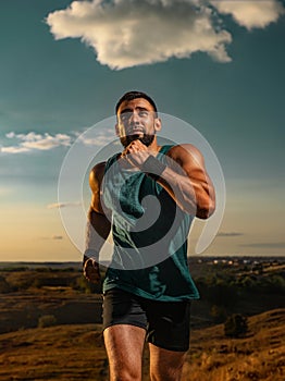 Runner. Trail run. Athlete sprinter outdoor. Athletic man running on sunset wearing in the sportswear. Fitness and sport