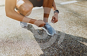 Runner trying running shoes getting ready for run. Healthy lifestyle