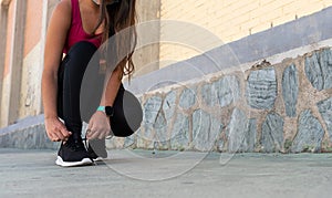 Runner tying her shoes before going for a run