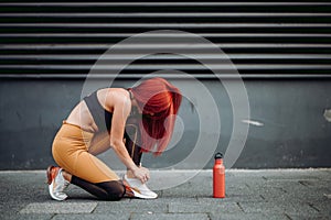 runner tying shoes and working out. Fitness details