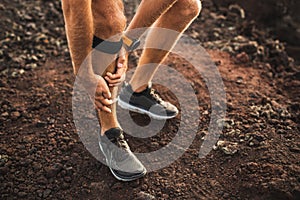Runner using Knee support bandage with leg injury photo